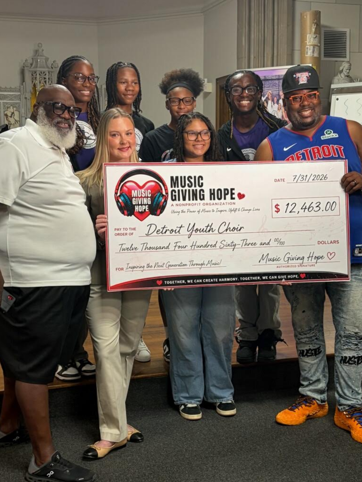 Music Giving Hope presenting a donation check to the Detroit Youth Choir